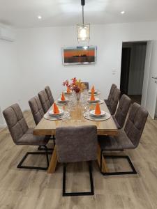 a dining room table with chairs and orange slices on it at Viola Metković in Metković