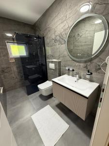 a bathroom with a sink and a toilet and a mirror at Viola Metković in Metković