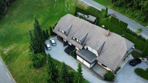 an overhead view of a large house with cars parked at Dih narave in Stahovica