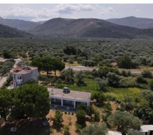 an aerial view of a house with mountains in the background at LaMar in Skala Prinou