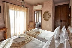 a hotel room with two beds and a mirror at Silver Coast Beach Residence in Baleal