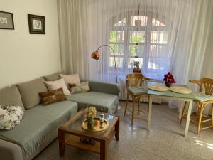 a living room with a couch and a table at Apartments Loket No 59 se zahradou in Loket