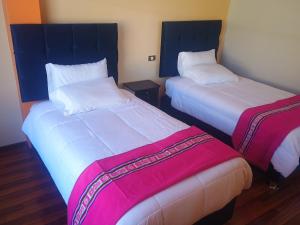 two beds sitting next to each other in a room at Luquina homestay in Puno +53 photos