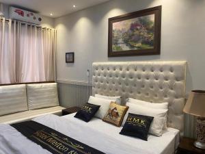 a bedroom with a large white bed with pillows at Hotel Milton islamabad in Islamabad +23 photos