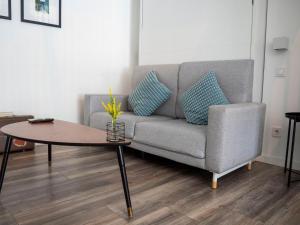 a living room with a couch and a table at Apartments Central Madrid - q2home in Madrid