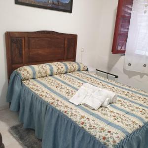 a bed with two pillows on top of it at Casita de Aldea in Sotrondio