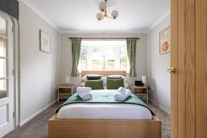 a bedroom with a bed with two towels on it at Pilkington House in Hathern