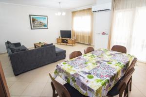 a living room with a table and a couch at Georgia's Apartment in Flogita