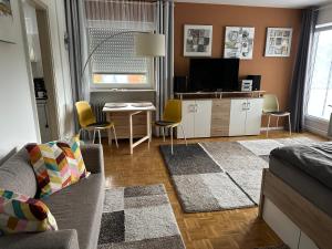 a living room with a couch and a table at Haus - Sonneck in Schonwald im Schwarzwald