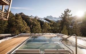 a swimming pool with a view of the mountains at Florisa Mountain Chalet in Tires