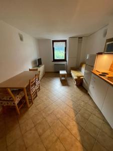 a kitchen and dining room with a table and a couch at Carola Dodici in Mezzana