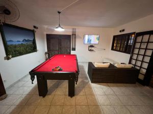 a room with a pool table and a couch at pousada marèatoa 9 in São Sebastião