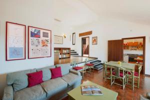 a living room with a couch and a table at Porto Ercole Maison vista mare in Cala Galera