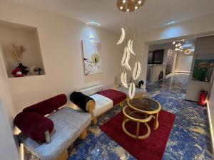 a living room with two couches and a table at Gold Palace Hotel in Cairo