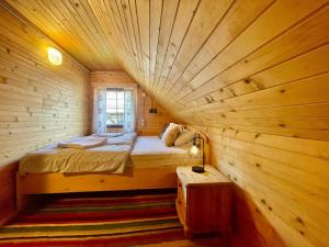 a bedroom with a bed in a log cabin at Vacation cottage house Enya in Koprivnik v Bohinju