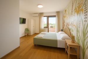 a bedroom with a large bed and a window at GuestHouse dei Fiori - Hituscany in Pisa