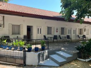 a building with a patio with chairs and tables at Avli Studios in Kokkino Nero +19 photos