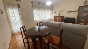 a living room with a couch and a table at Piso Mirador de San Cosme in San Cosme de Barreiros