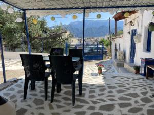 a table and chairs on a patio with a view at Leonidas apartments 1 in Sparta