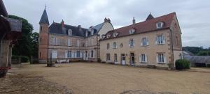 an old castle with a large courtyard in front of it at Domaine Les Malaitries - Château de La Chapelle Baloue 