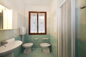 a bathroom with a toilet and a sink at Villa Albina in Eraclea Mare