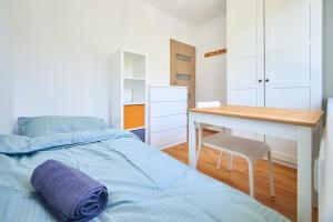 a bedroom with a bed and a desk at Korczak Centrum Olsztyn in Olsztyn