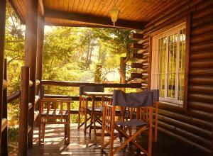 a porch of a cabin with a table and chairs at Cabañas Las Golondrinas in Potrerillos