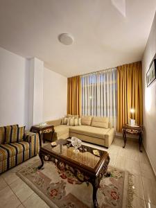 a living room with a couch and a coffee table at Modern Apartment in Prime Location - Jabal Amman in Amman