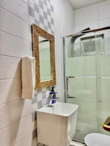 a bathroom with a sink and a shower and a mirror at Modern Apartment in Prime Location - Jabal Amman in Amman +6 photos