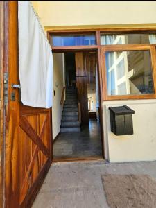 an open door of a house with a staircase at Puerto Encuentro in Mar Azul +2 photos