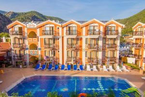 a hotel with a swimming pool in front of a building at Magic Tulip Beach Hotel in Oludeniz