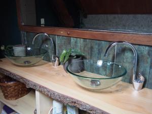 a bathroom sink with two faucets on a wooden counter at La Sorcière et le Korrigan in Paimpont +21 photos