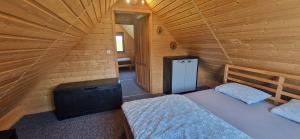 Postel nebo postele na pokoji v ubytování Domek Wypoczynkowy W Brajnikach