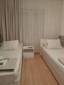 Postel nebo postele na pokoji v ubytování Apartmani Nis