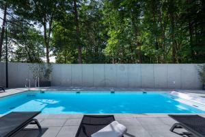 a swimming pool in a backyard with a fence at Eden Sea in Międzyzdroje +16 photos