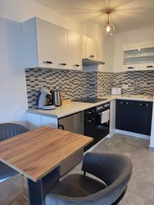 a kitchen with a wooden table and a counter top at Feriewohnung Alexandra in Bad Neuenahr-Ahrweiler