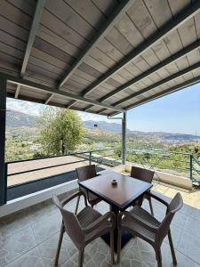 a table and chairs on a balcony with a view at Pashaj Himare Guest House in Himare