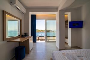 a bedroom with a bed and a view of the ocean at Lluka Sea Side in Sarandë