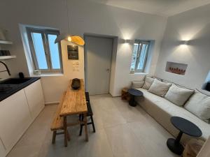 a living room with a couch and a table at Ola House Dryopida Kythnos in Dhriopís