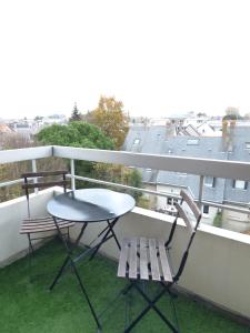 a table and chairs on a balcony with a view at Type 2 Catho Esa in Angers