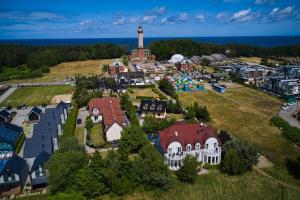 an aerial view of a small town with a lighthouse at Villa Scolia in Niechorze