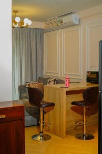 a living room with a couch and two bar stools at Artesano Park View Furnished Apartment in Nairobi +37 photos