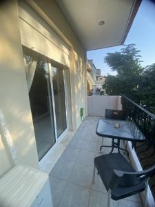 a patio with a table and chairs on a balcony at Dimi's home in Komotini