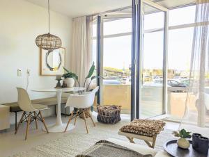 a living room with a table and chairs at Strandstudio Lumare in Bergen aan Zee