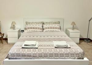 a bedroom with a large bed with two night stands at Monolocale Cora in Corsano