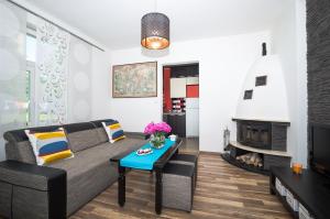 a living room with a couch and a fireplace at Apartament Sopot Kamienny Potok in Sopot