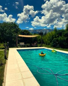 a pool with a person in a raft in the water at La higuera in Cerro de Oro +19 photos