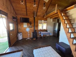 a living room with a staircase in a log cabin at Domek na reset in Busko-Zdrój