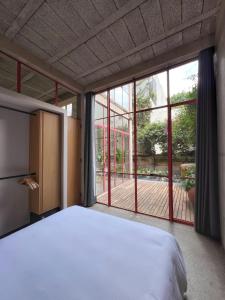 a bedroom with a bed and a large window at Xolo Condesa in Mexico City