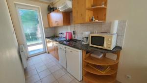 a kitchen with a counter top with a microwave at Holiday home in Szantod - Balaton 20221 in Szántód